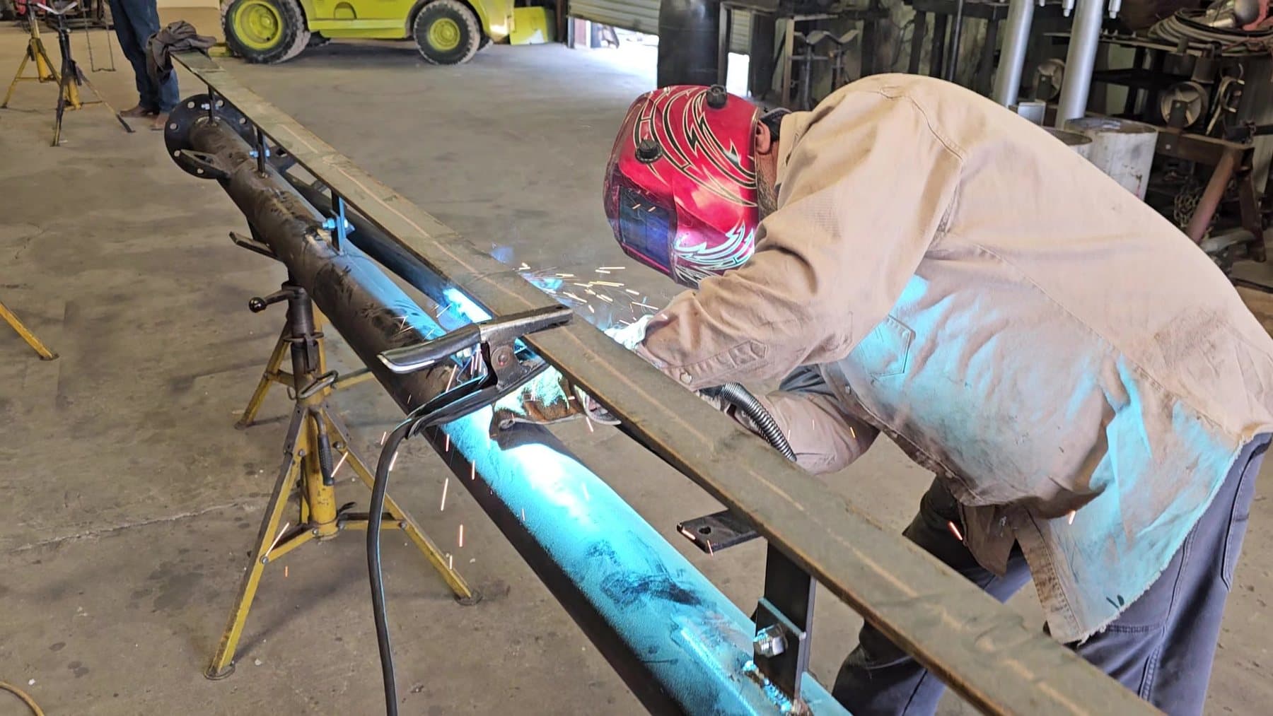 Welder fabricating a flare stack in a Midland, Texas shop
